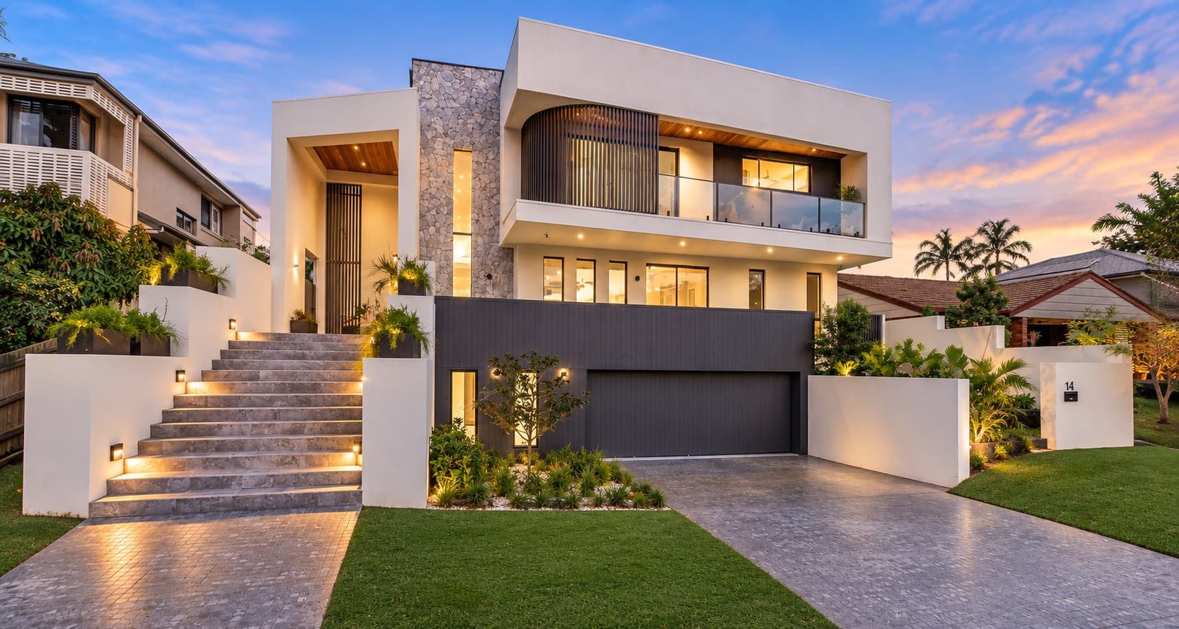 contemporary home with mixed cladding, large corner glazing, and a raised entry portico — SNG Engineers