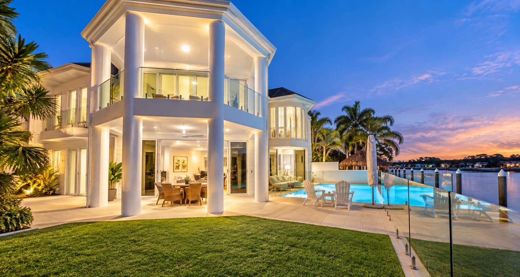 architectural residence with a flat skillion roof, dark steel columns, and recessed upper-floor deck — SNG Engineers