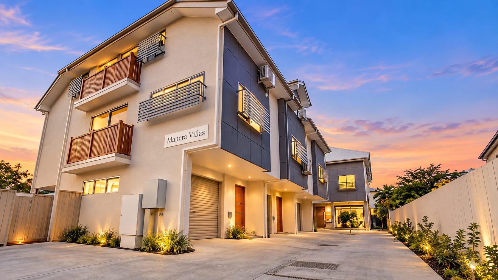 rendered three-storey villa complex entry at dusk with cantilevered upper floor and signage wall — SNG Engineers