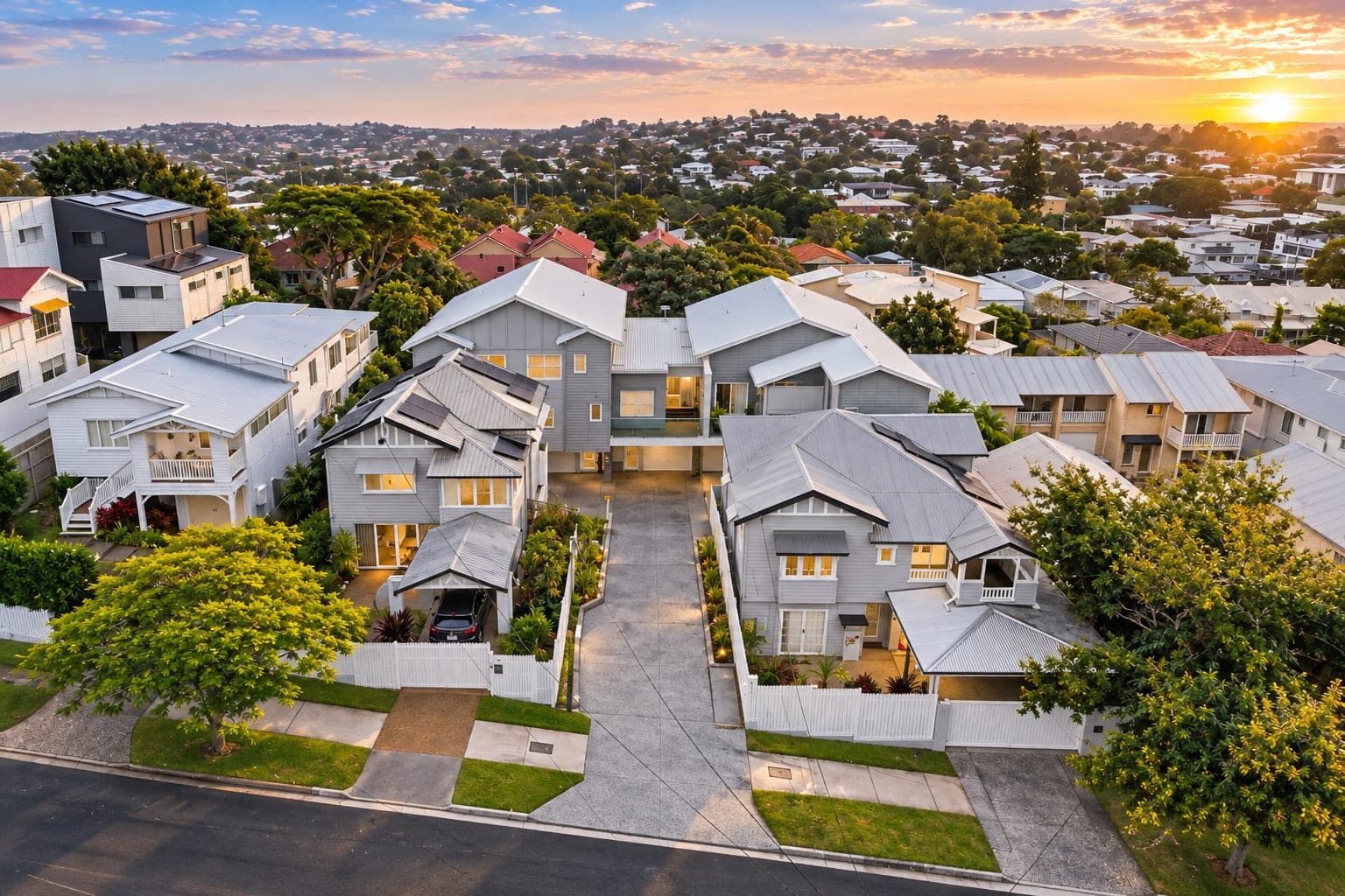 aerial dusk view of Queenslander-style multi-unit development sharing a driveway between two homes — SNG Engineers