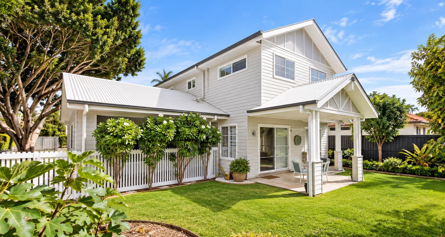 rear elevation of a white weatherboard project home showing a gabled verandah and covered patio — SNG Engineers