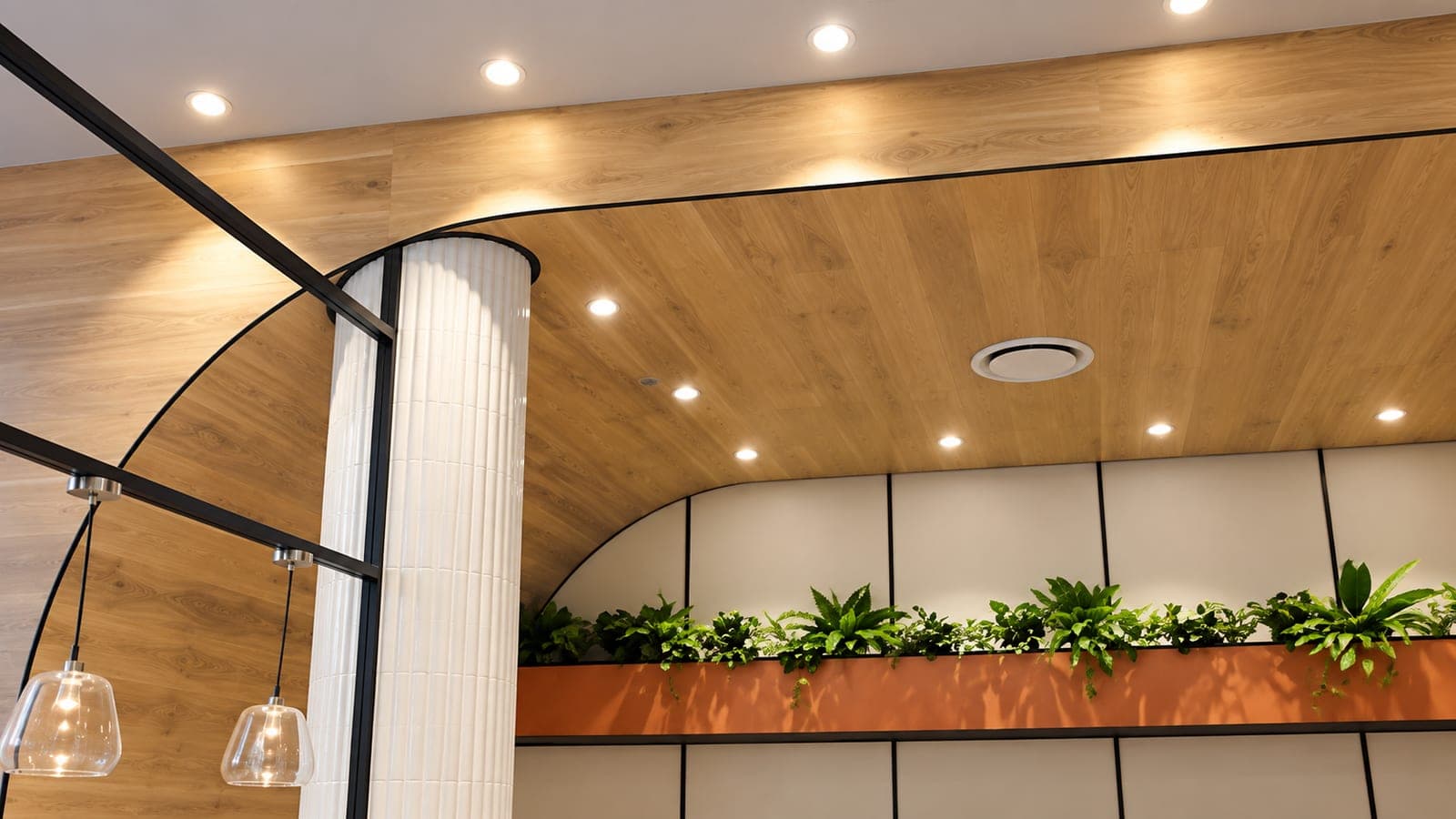 Curved timber ceiling bulkhead with recessed lighting in a commercial fitout