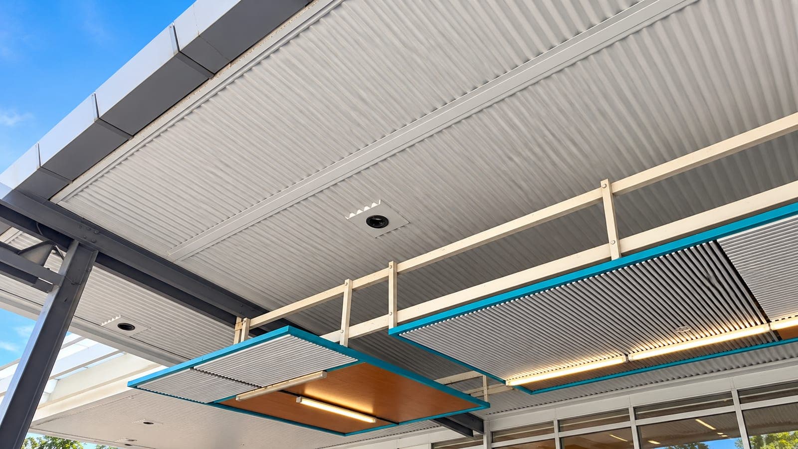 Structural steel-framed exterior canopy on a commercial shopfront