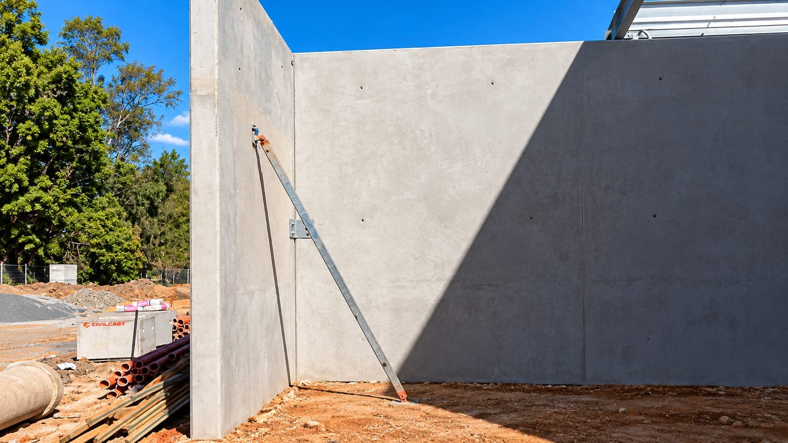 Braced tilt-up concrete panel corner with temporary raking props